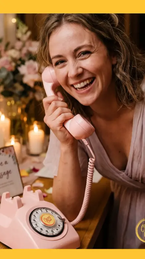 Reel still: a guest laughing into a pink retro phone